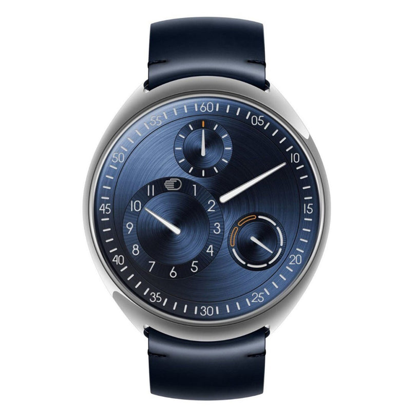 The Ressence TYPE 1° Slim Navy is a modern wristwatch featuring a blue dial, distinctive subdials, and a dark leather strap, shown from an overhead perspective.