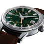 Close-up of the Grand Seiko Automatic GMT Elegance wristwatch, featuring a Mount Iwate dial in British Racing Green, gold GMT hand, date window, and brown leather strap.