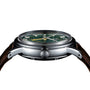 Side view of the Grand Seiko Automatic GMT Elegance wristwatch with a British Racing Green dial, silver case, visible GS-marked crown, and brown leather strap.