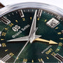 Close-up of a Grand Seiko Automatic GMT Elegance, featuring a British Racing Green Mount Iwate dial with time, date, and 24-hour markers—crafted to Grand Seiko Standard.