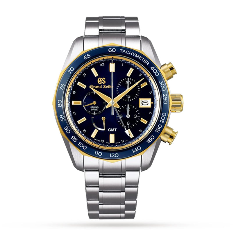The Grand Seiko Spring Drive Chronograph Sport watch features an 18k yellow gold and blue bezel, silver and gold accents, and a stainless steel bracelet, all shown on a white background.