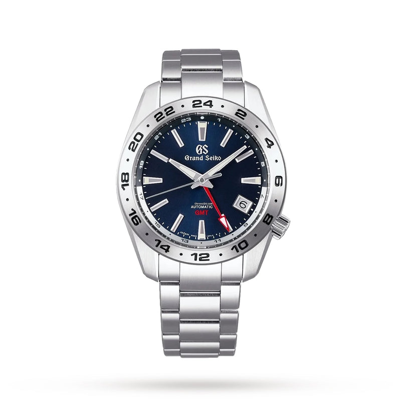 The Grand Seiko Automatic GMT Sport is a stainless steel watch featuring a blue dial, luminescent hands and markers, and a red GMT hand for tracking dual time, shown on a white background.
