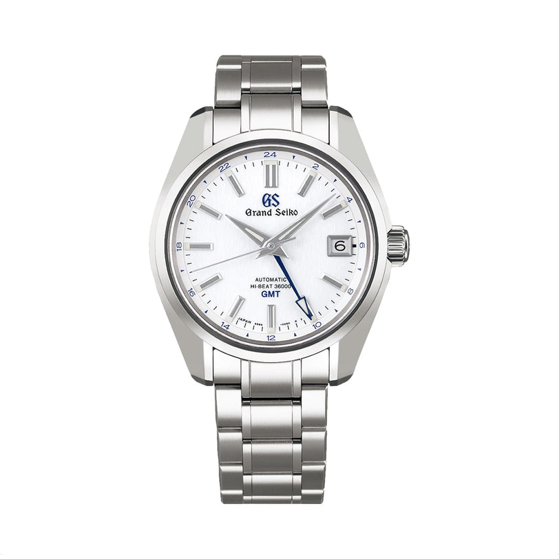 The Grand Seiko Hi-Beat GMT Heritage features a stainless steel case, white dial, blue GMT hand, date window at 3 o’clock, and metal link bracelet, displayed on a white background.