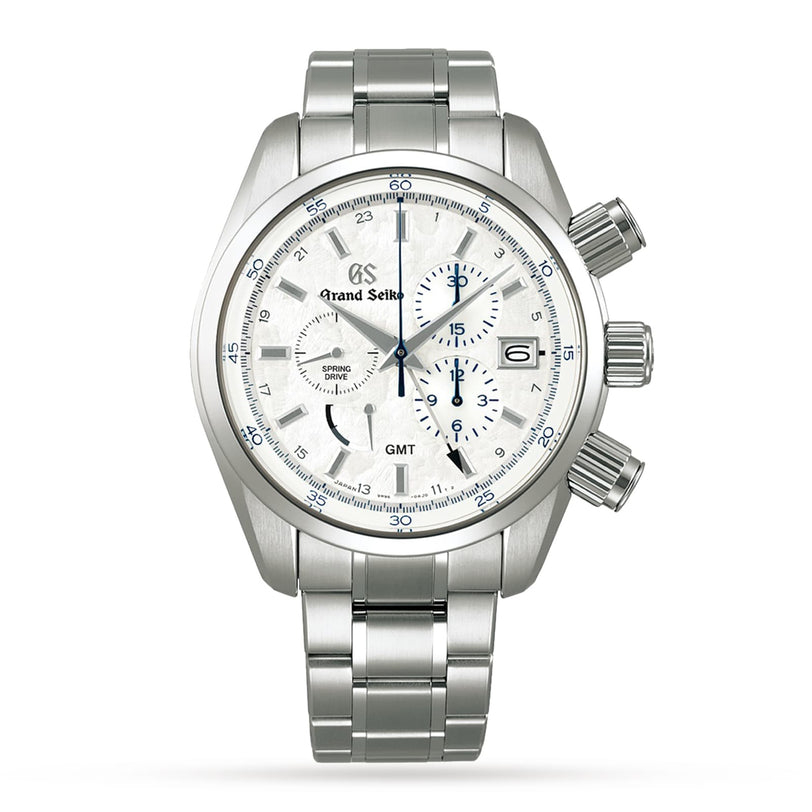 The Grand Seiko Spring Drive Chronograph Sport features a stainless steel case, white textured dial with three subdials, blue accents, a date window at 3 o’clock, and a metal link bracelet.