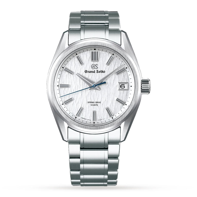 The Grand Seiko Spring Drive 5 Days Evolution 9 is a stainless steel wristwatch with a silver textured dial inspired by Japanese nature, blue second hand, Spring Drive movement, date at 3 o’clock, and a metal bracelet band.
