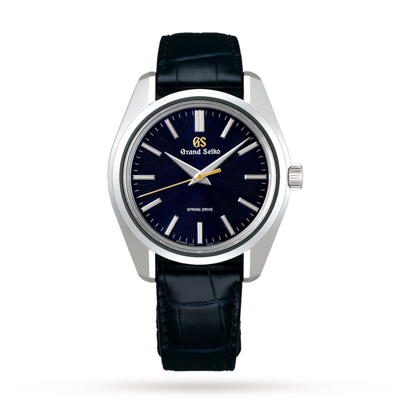 The Grand Seiko Spring Drive Heritage wristwatch features a black leather strap, silver case, dark blue dial, silver hour markers, and gold accents. Displayed on a white background, this limited-edition piece epitomizes sophistication and timeless style.