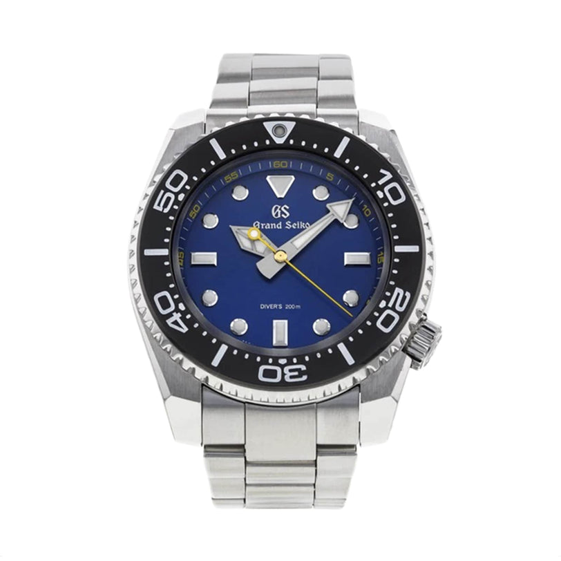 The Grand Seiko Quartz GMT Sport features a blue dial, black bezel, silver indices, and a stainless steel bracelet. Handmade in Japan, it displays 1:56:44.
