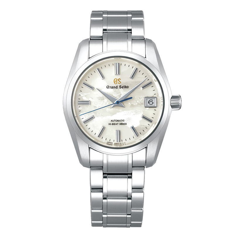 The Grand Seiko Hi-Beat Heritage is a stainless steel wristwatch with a silver textured dial, silver hour markers, date at three oclock, 9S85 automatic movement, and a metal link bracelet.