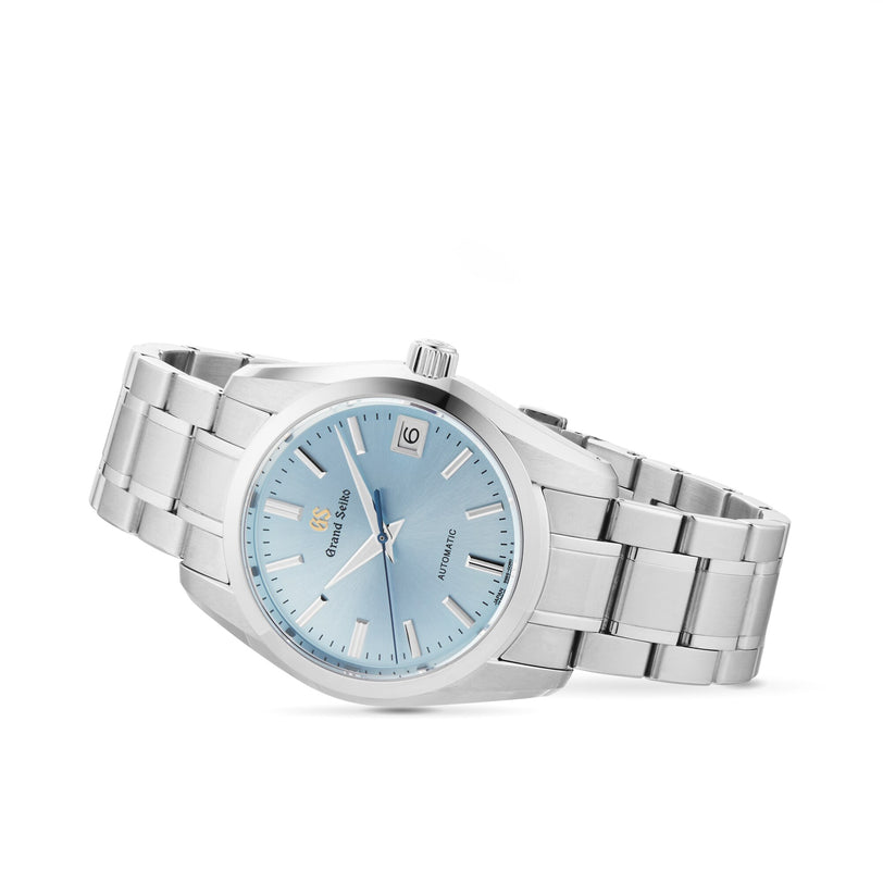 The Grand Seiko Automatic Heritage 25th anniversary limited edition features a stainless steel case, light blue dial, silver hour markers, and a date window at 3 o’clock.