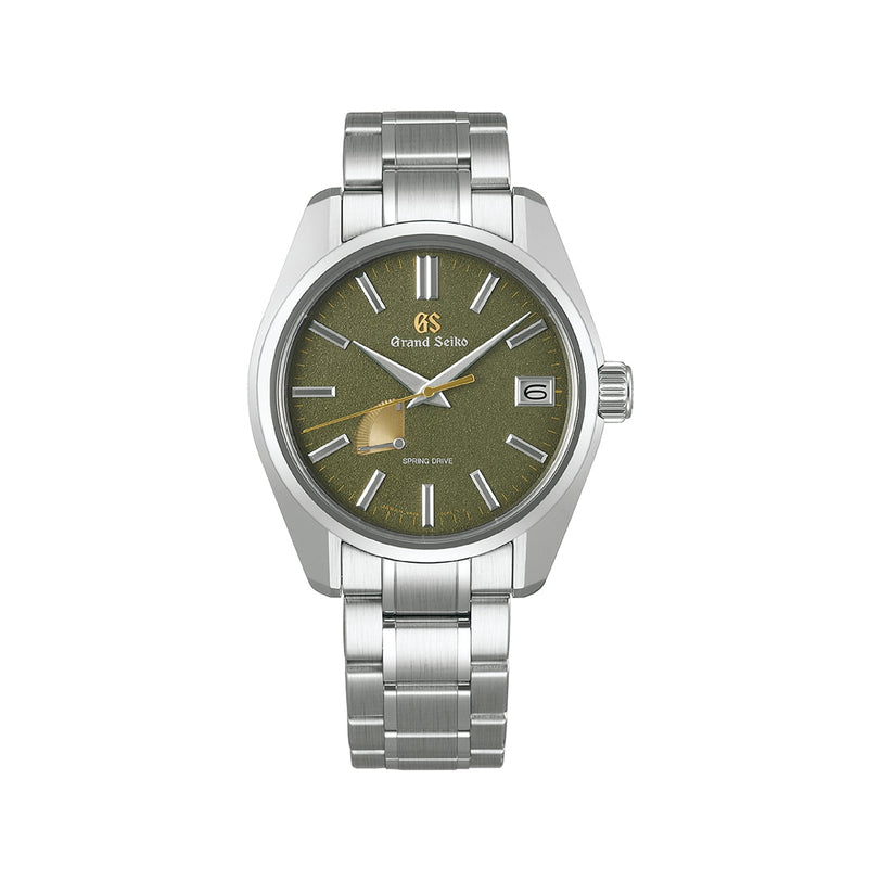 The Grand Seiko Spring Drive Heritage features a green textured dial, gold seconds hand, date at 3 oclock, and stainless steel bracelet—crafted with the precision and artistry inspired by Japanese swordmaking.