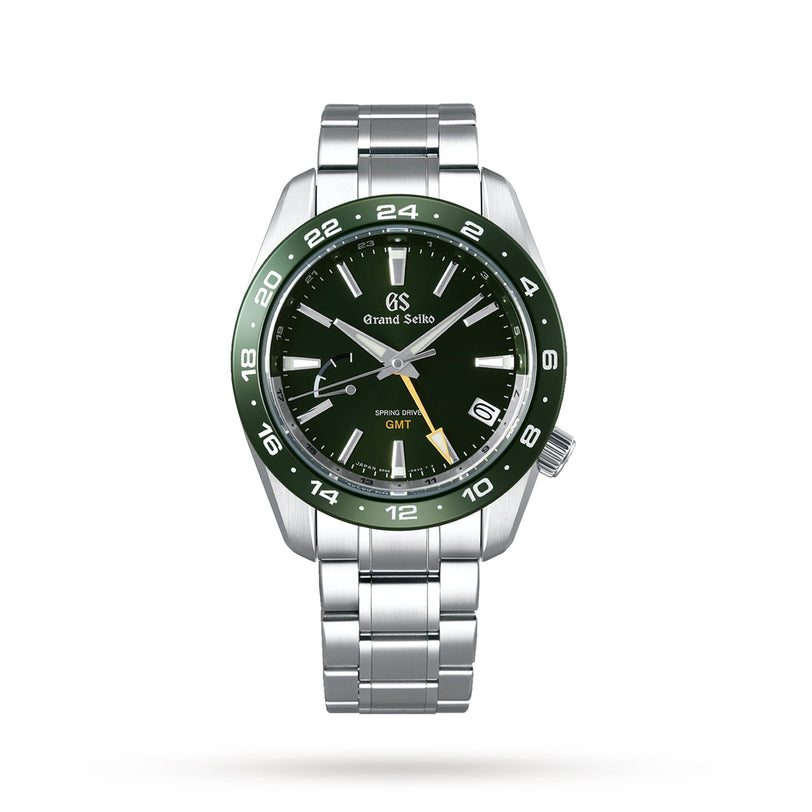 The Grand Seiko Spring Drive GMT Sport wristwatch features a green ceramic bezel, green dial, silver hour markers, yellow GMT hand, and a stainless steel bracelet, displayed on a white background.