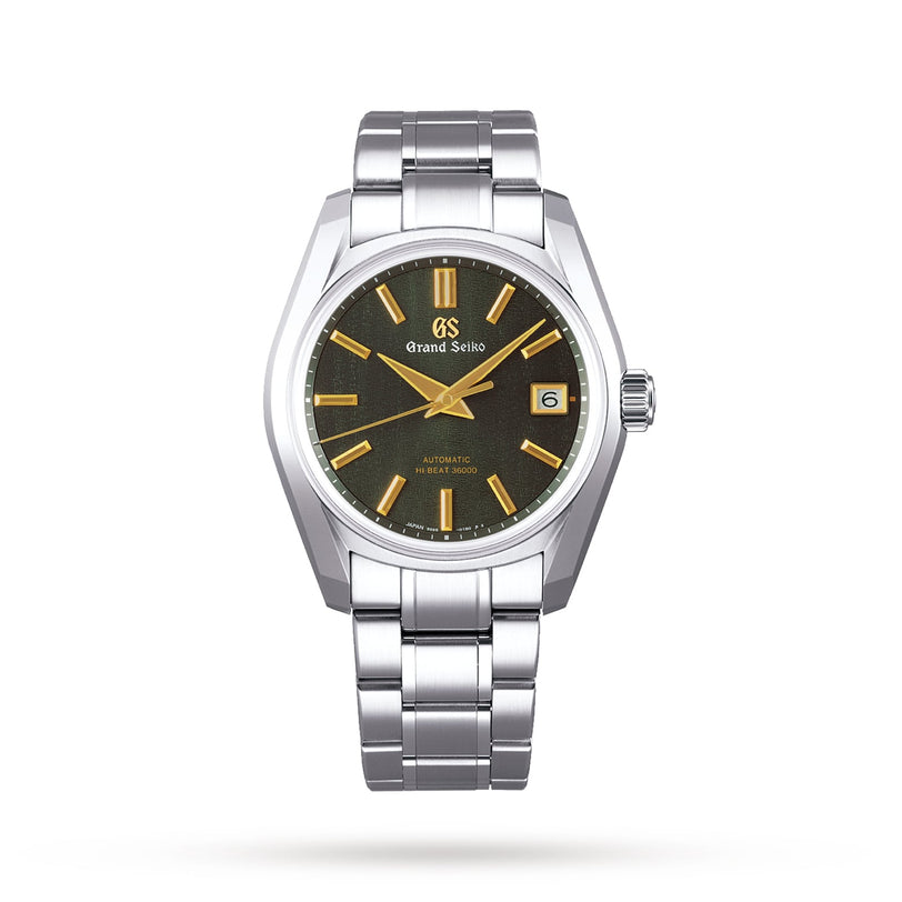 The Grand Seiko Hi-Beat Heritage is a stainless steel wristwatch with Zaratsu polishing, black dial, gold hour markers, date at 3 o’clock, and a metal bracelet—displayed against a plain white background.