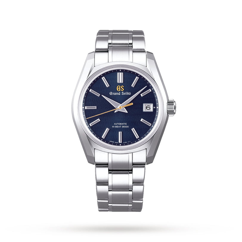 The Grand Seiko Hi-Beat Heritage is a stainless steel wristwatch with a blue dial, silver hour markers, 9S85 mechanical movement, date display at 3 o’clock, and metal bracelet from the Japanese Seasons collection.