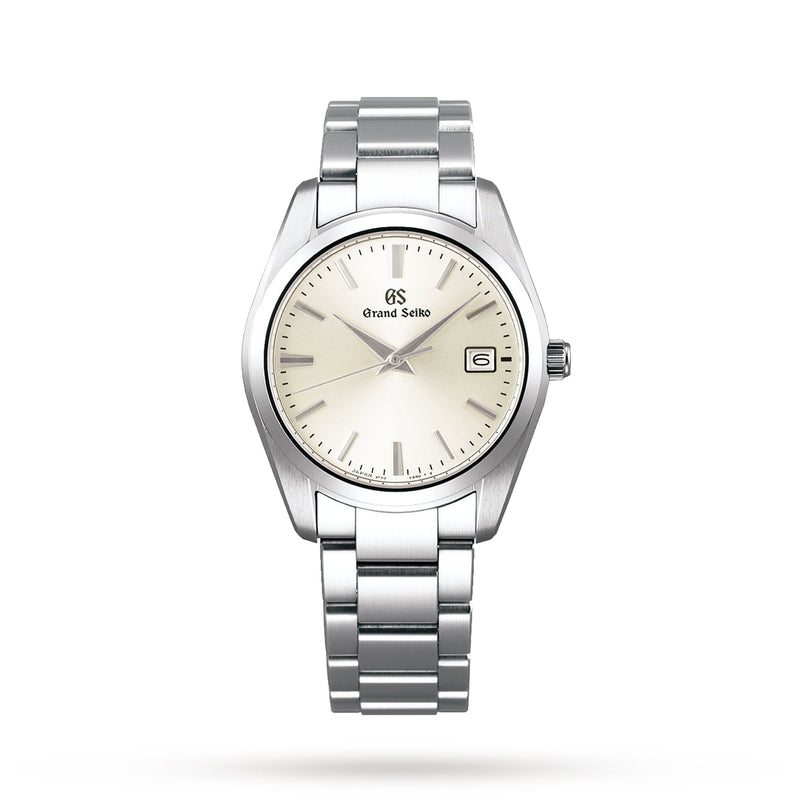 The Grand Seiko Quartz Heritage is a stainless steel wristwatch featuring a silver dial, date window at 3 o’clock, silver hour markers, and a metal link bracelet.