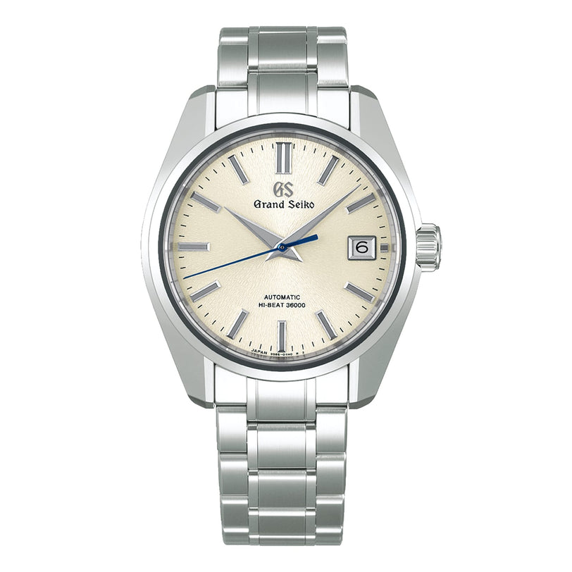 The Grand Seiko Hi-Beat Heritage is a silver Ever-Brilliant Steel wristwatch with a light beige dial, date at 3 oclock, silver metal bracelet, and Hi-Beat 36000 above 6 oclock.