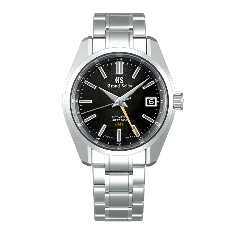 The Grand Seiko Hi-Beat GMT Heritage is a stainless steel watch with a black dial, silver hour markers, date at 3 oclock, metal bracelet, and precise 9S86 automatic movement.