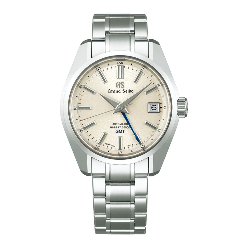 The Grand Seiko Hi-Beat GMT Heritage wristwatch features a beige dial, blue GMT hand, date window at 3 o’clock, and an Ever-Brilliant Steel bracelet.