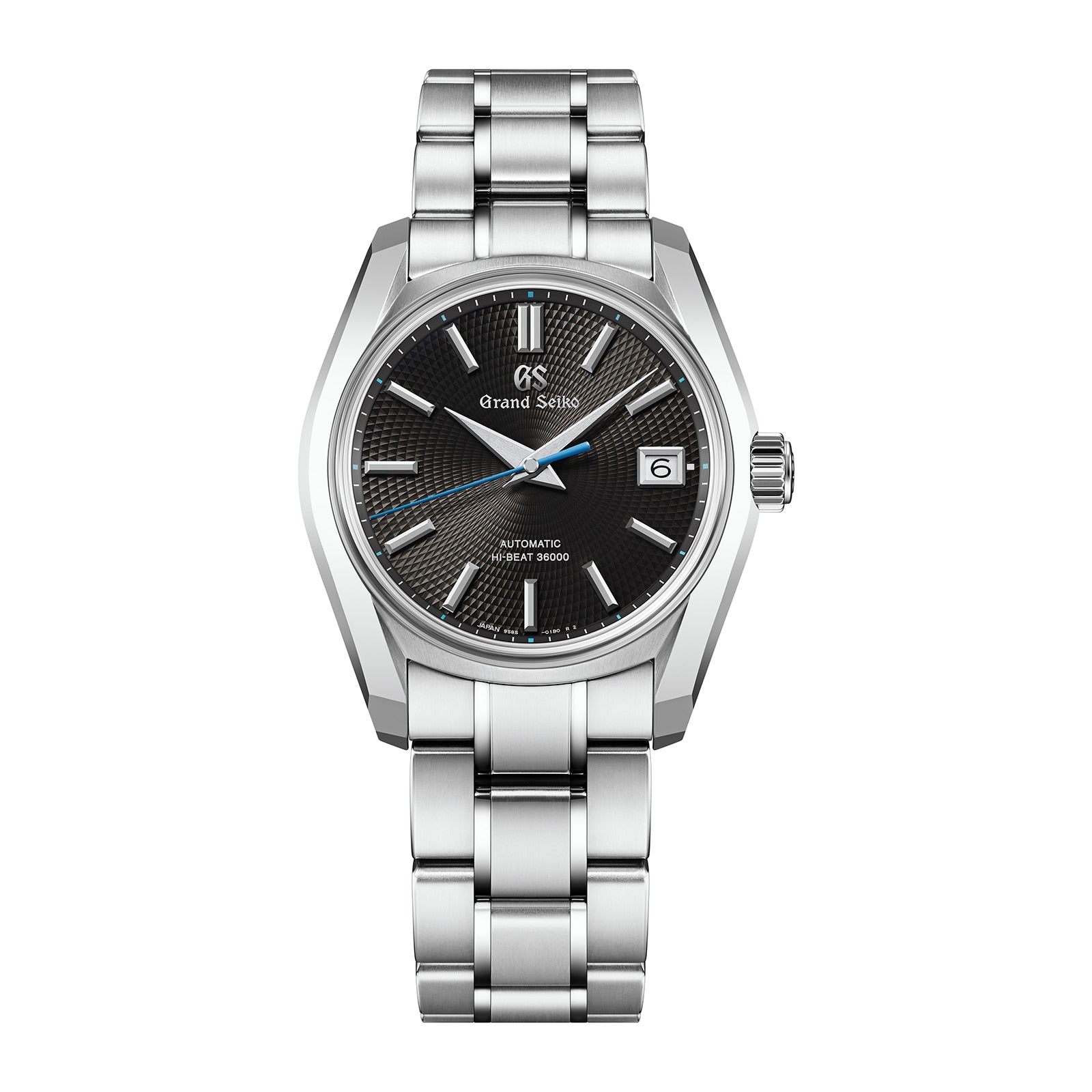 The Grand Seiko Hi-Beat Heritage is a stainless steel wristwatch with a black textured dial inspired by Jodogahama beach, silver indices, date at 3 o’clock, and a metal link bracelet.