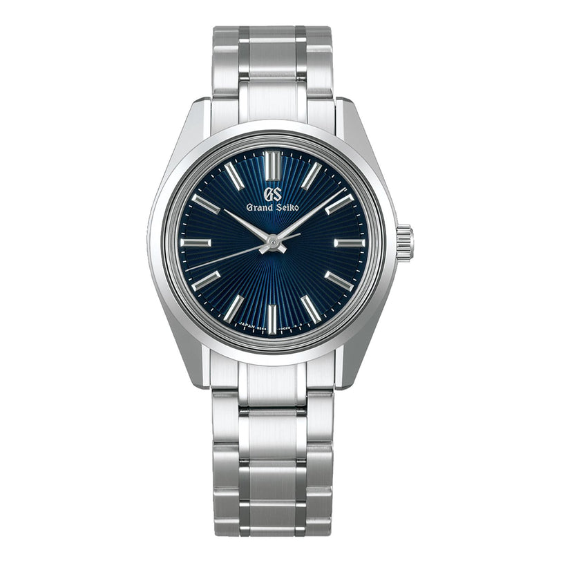 The Grand Seiko Manual Heritage is a stainless steel wristwatch from the Heritage Collection, featuring a blue textured dial, silver hour markers, and a linked metal bracelet powered by the precise 9S64 movement.