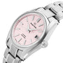 The Grand Seiko Hi-Beat Heritage features a stainless steel case, pink textured dial, silver hour markers, date window at 3 o’clock, metal bracelet, and is powered by the hi-beat 9S85 movement.