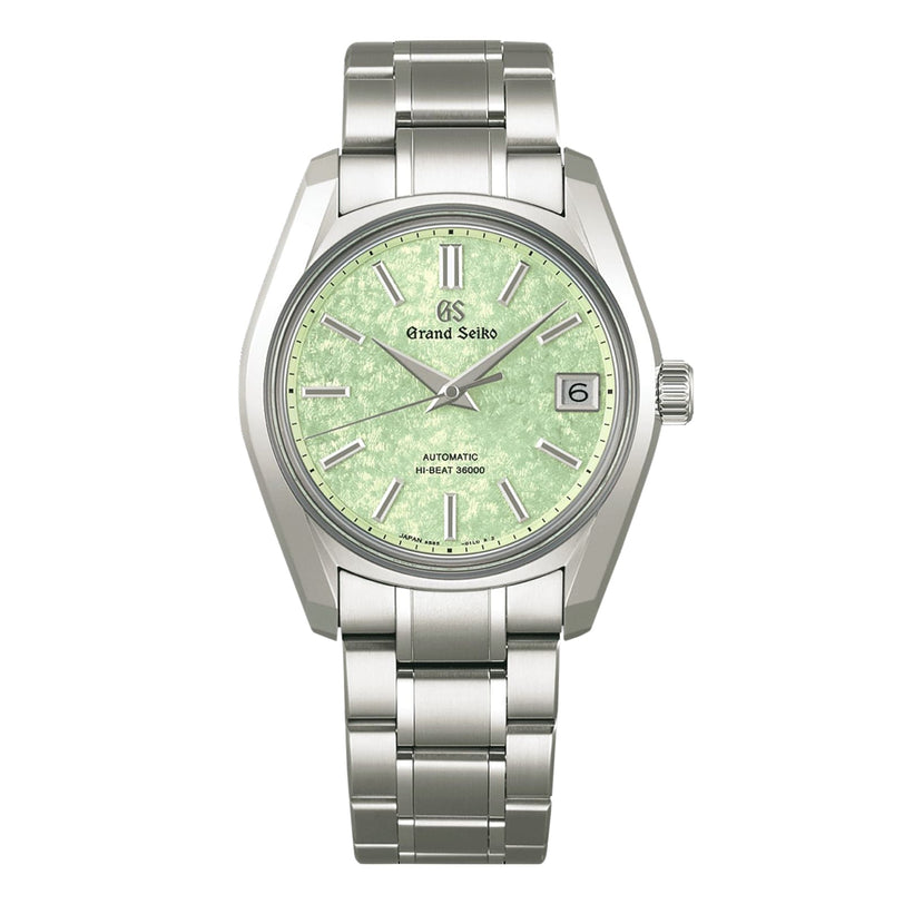 The Grand Seiko Hi-Beat Heritage features a green textured dial, silver hour markers, date window at 3 oclock, automatic movement, and a titanium case on a matching metal bracelet.