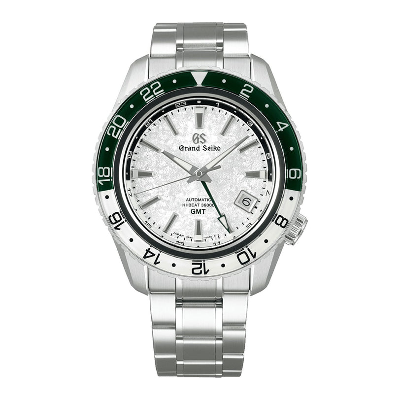 A Grand Seiko Hi-Beat GMT Sport watch in stainless steel with a white textured dial, green and white bezel, date display, and metal bracelet is shown on a white background.