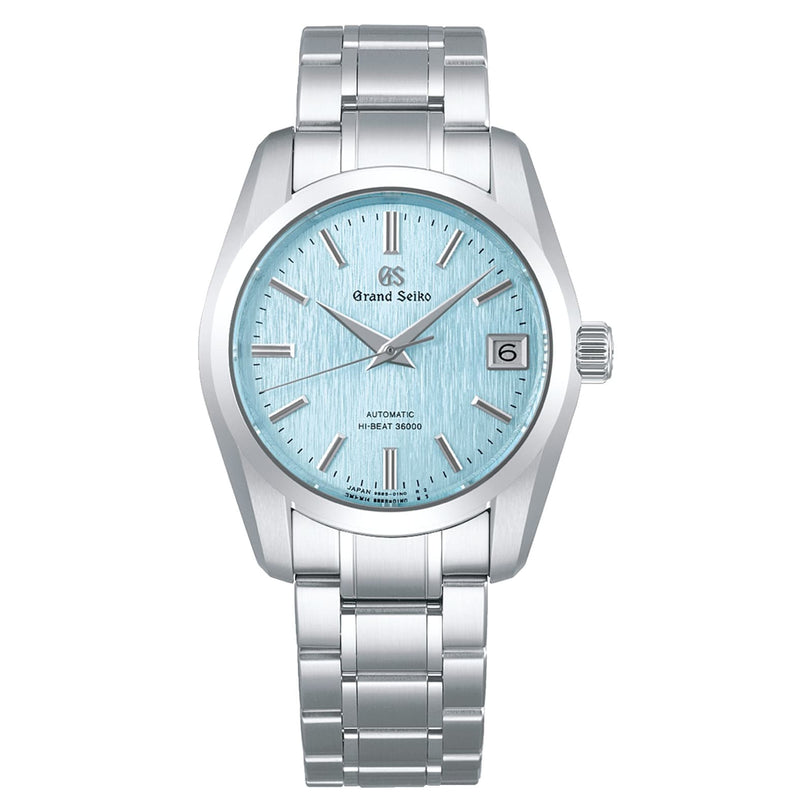 The Grand Seiko Hi-Beat Heritage wristwatch boasts Ever-Brilliant Steel, a light blue textured dial, silver markers and hands, date at 3 o’clock, Hi-Beat Caliber 9S85 movement, and a sleek metal bracelet.