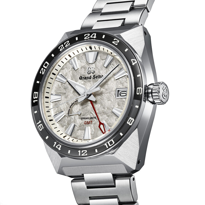 The Grand Seiko Spring Drive GMT Sport features a textured white dial, stainless steel case and bracelet, 9R66 Spring Drive GMT movement, and a date display at 3 o’clock.