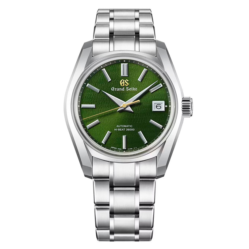 The Grand Seiko Hi-Beat Heritage is a stainless steel wristwatch featuring a deep green textured dial, silver hour markers, a date window at 3 o’clock, Zaratsu polishing, and a silver metal bracelet.