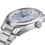 The Grand Seiko Hi-Beat 80 Hours Evolution 9 is a stainless steel wristwatch featuring a textured light blue mountainscape-inspired dial, silver hour markers, date window, and metal bracelet, shown on a white background.