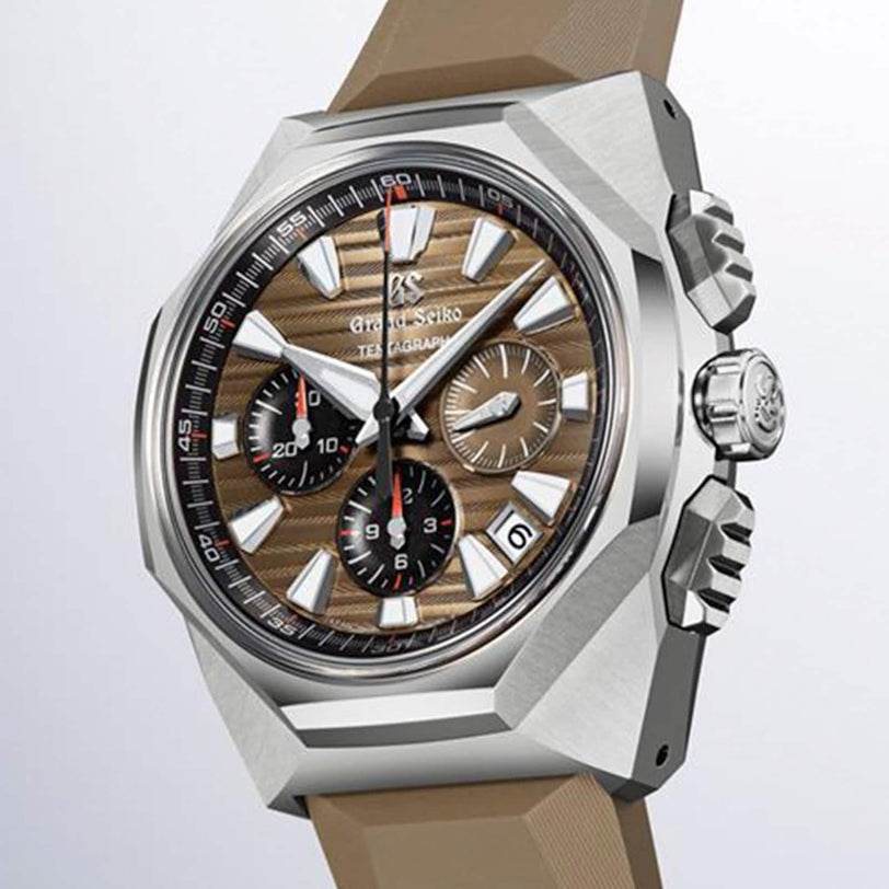 A close-up of the Grand Seiko Hi-Beat 36000 Automatic Chronograph SLGC007 Evolution 9, featuring a brown textured dial, multiple subdials, silver indices, and a beige strap.