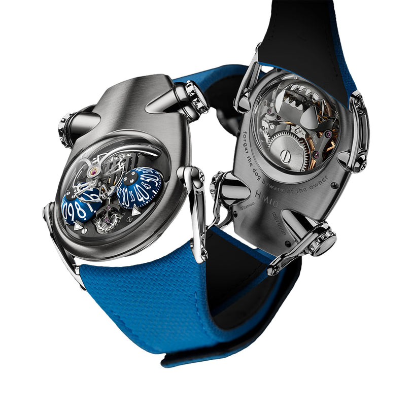 Two MB&F Horological Machine N°10 Bulldog wristwatches with blue straps, featuring futuristic designs and visible intricate gears and dials.