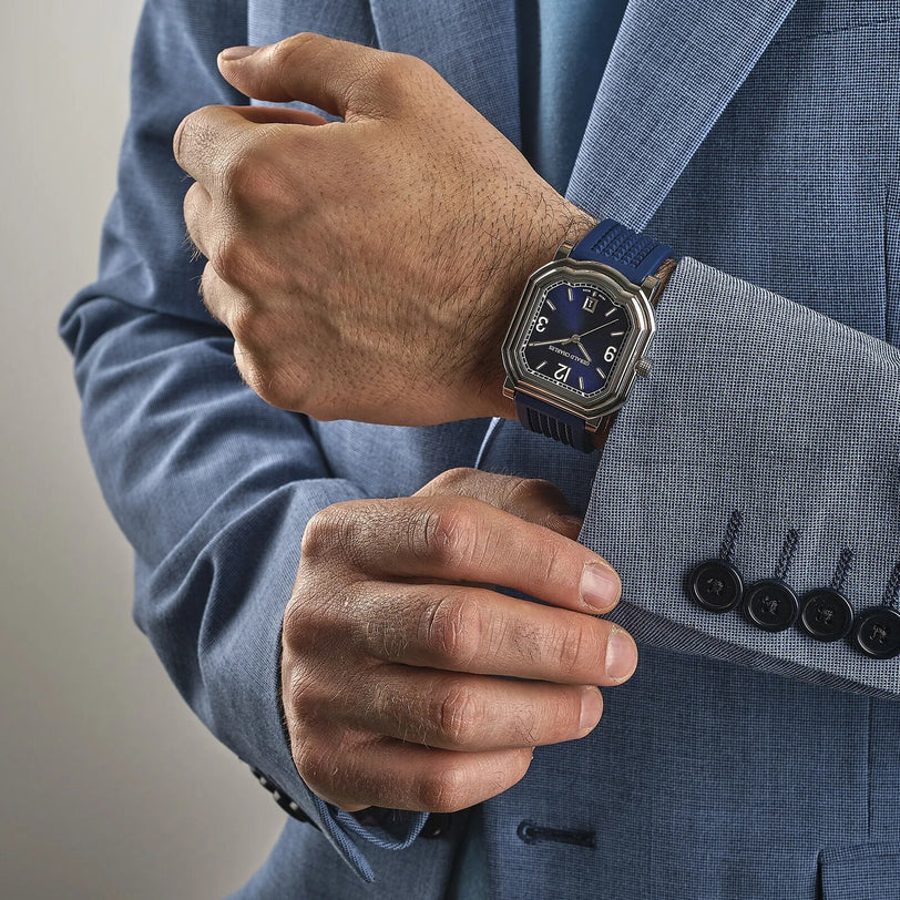 A man in a blue suit with the Gerald Charles Maestro GC Sport on his left wrist