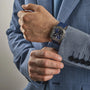 A man in a blue suit with the Gerald Charles Maestro GC Sport on his left wrist