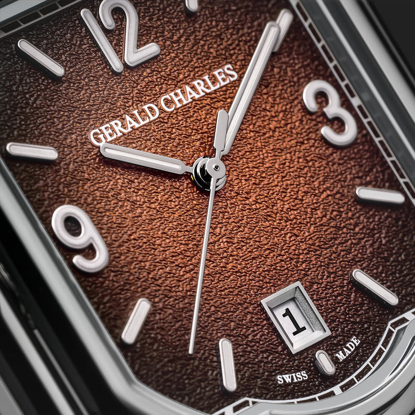 Close-up of a Gerald Charles Maestro GC Sport watch featuring a textured brown dial, silver hour markers, and the date set to 1.