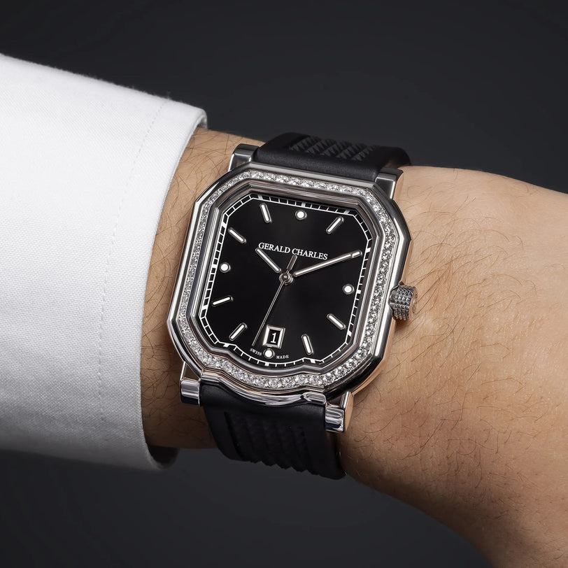 A Gerald Charles Maestro 2.0 Ultra-Thin Gem-Set wristwatch with a black rubber strap is worn on a person’s wrist, displaying the time as 10:10.