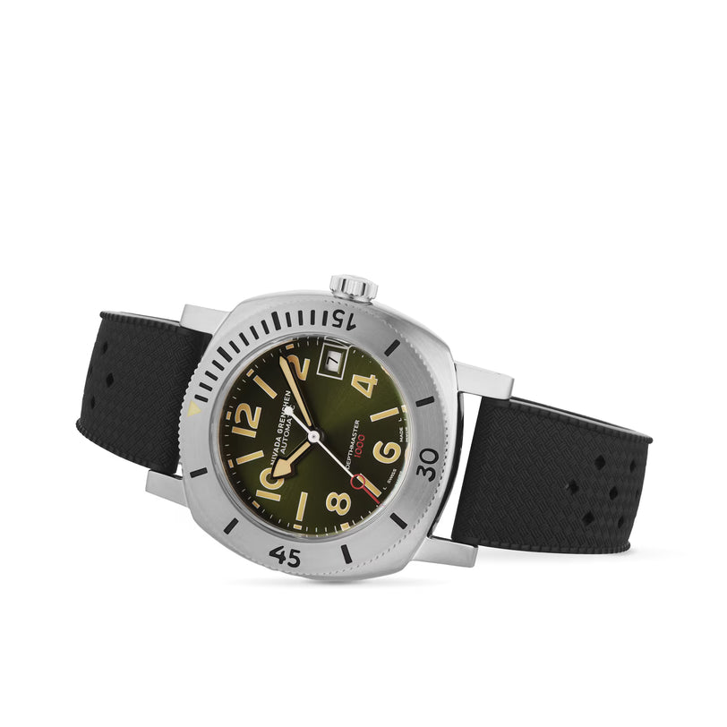 Stainless steel watch with olive dial, gold numerals, date window, and black rubber strap.