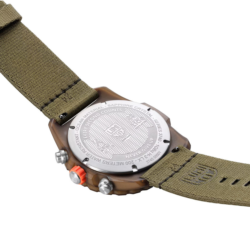 The back of the Luminox Bear Grylls Survival Eco Master Sustainable Outdoor watch features engraved details and an olive green fabric strap.