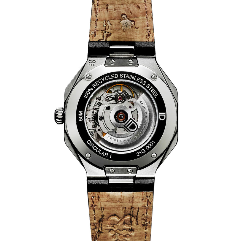 Back view of the ID Geneve Circular 1 - Mineral Grey wristwatch showcasing its visible mechanical movement and cork-patterned strap.