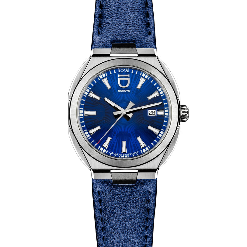 The Circular S - Blue Brushed by ID Geneve features a silver case, blue brushed dial, date display, and a matching blue leather strap.