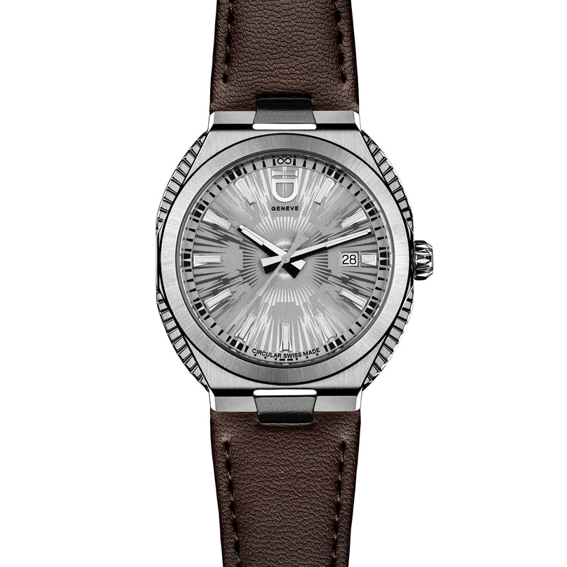 The ID Geneve Circular S - Silver Fluted wristwatch features a textured dial, date display, and brown leather strap, shown on a white background.