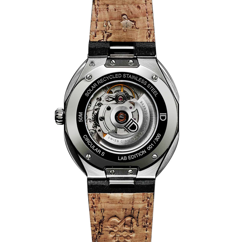 Back view of the ID Geneve Circular S - Green Brushed wristwatch, showcasing its visible mechanical movement and cork strap.