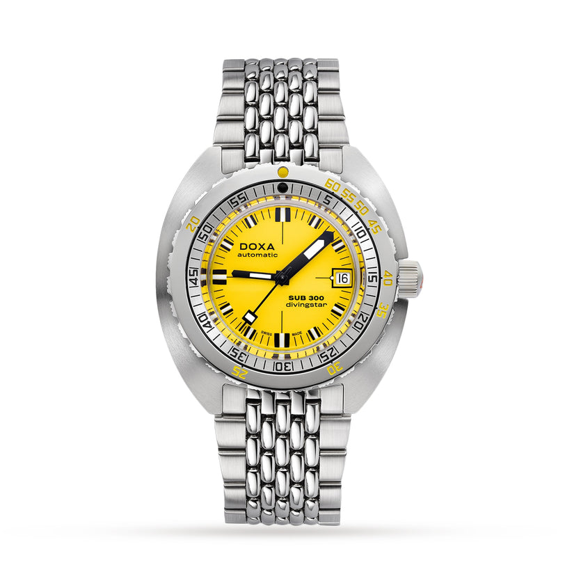 The DOXA Sub 300 Divingstar is a stainless steel diver’s watch with a yellow dial, silver indices, unidirectional bezel, date window at 3 o’clock, and a silver link bracelet.