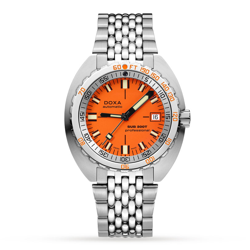The DOXA Sub 300T Professional is a stainless steel divers watch with an orange dial, black and white hands, date at 3 o’clock, silver bracelet, bezel with minute and depth scales, and a helium release valve.