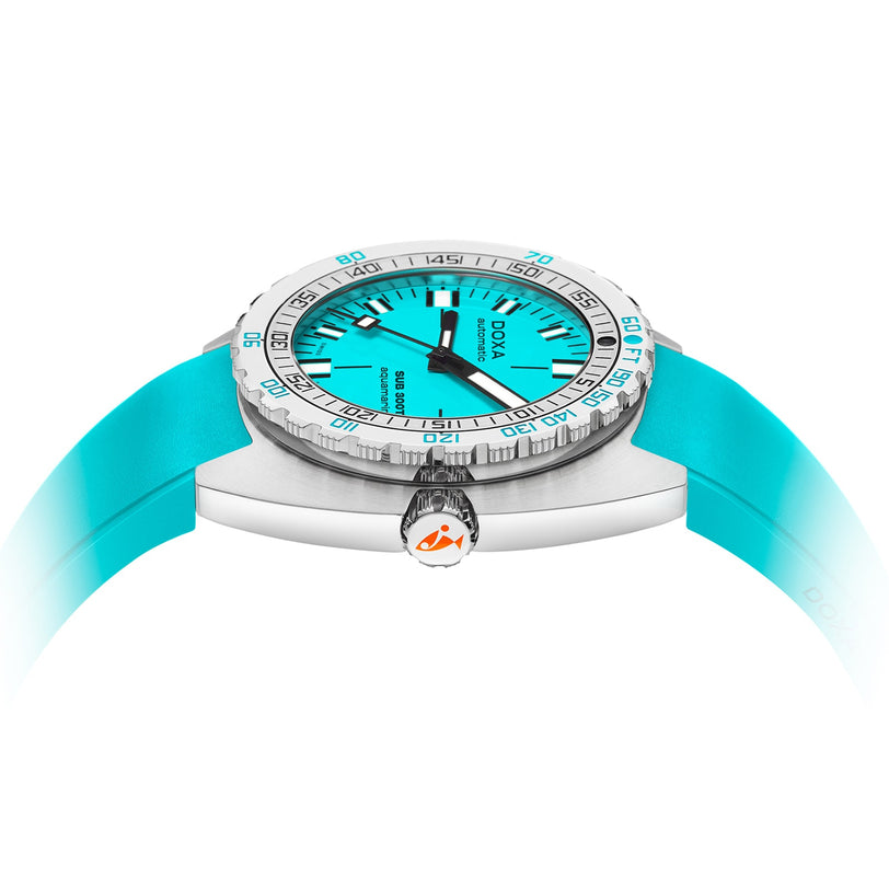 A close-up side view of the DOXA Sub 300T Aquamarine shows its turquoise dial, matching rubber strap, silver bezel, crown with the DOXA logo, and hands coated with Super-LumiNova for superior underwater visibility.