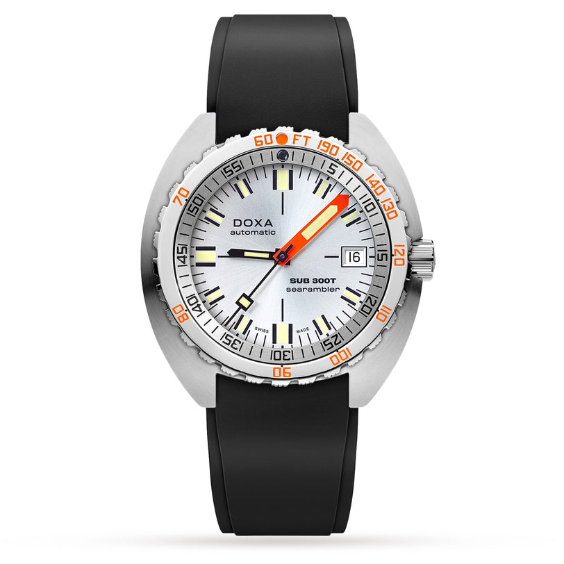 The DOXA Sub 300T Searambler is a silver diver’s watch with an orange-accented dial, black rubber strap, date at 3 o’clock, unidirectional bezel with depth/time markings, and is water-resistant to 200 meters.