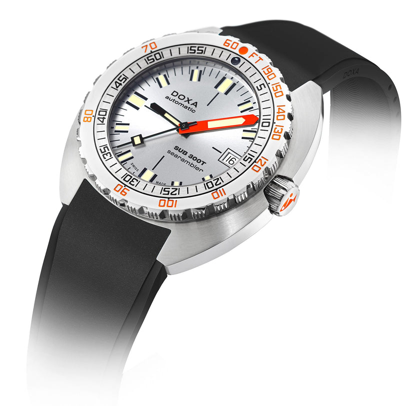 The DOXA Sub 300T Searambler features a silver case, black rubber strap, orange and black hand detailing, minute markers on a white dial, rotating bezel, and is water-resistant up to 200 meters for underwater reliability.