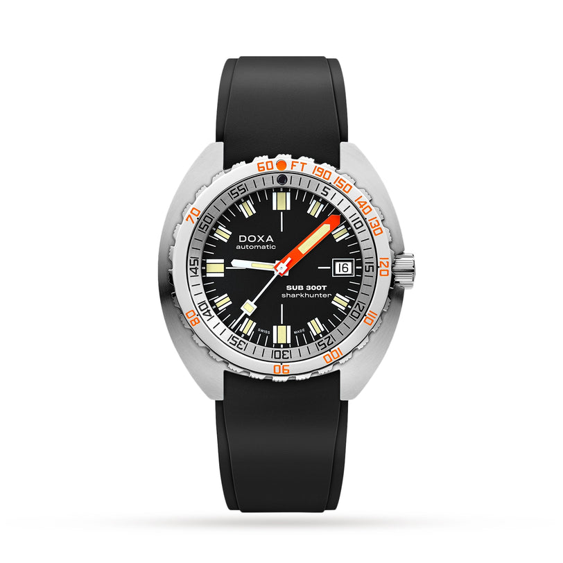The DOXA Sub 300T Sharkhunter is a diver’s watch with a black dial, black rubber strap, date window, orange-accented bezel with minute and feet markers, and a helium release valve for professional diving.