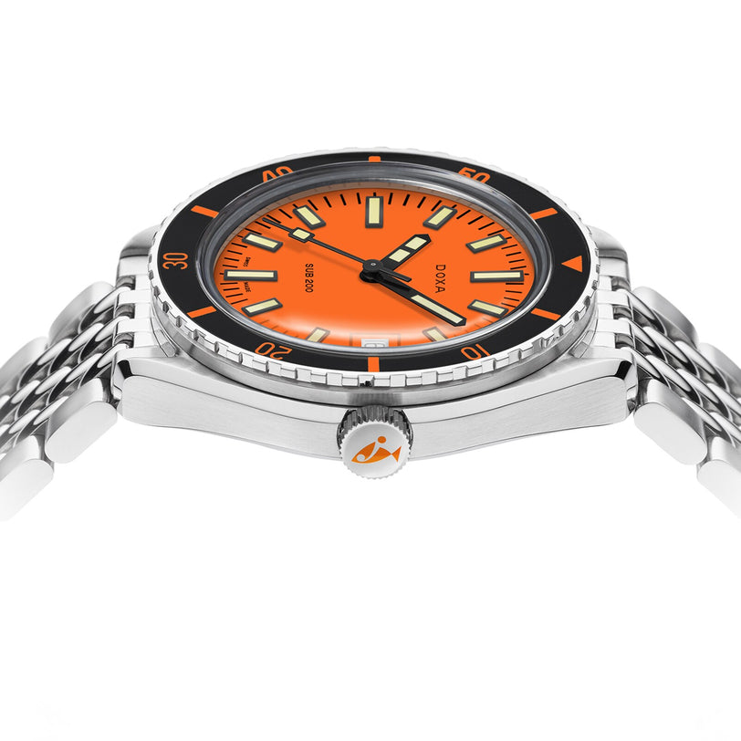 The DOXA Sub 200 Professional diver’s watch, made from 316L stainless steel, features an orange dial, black unidirectional rotating bezel, and silver bracelet. The brand is visible on both the face and crown in a side view.
