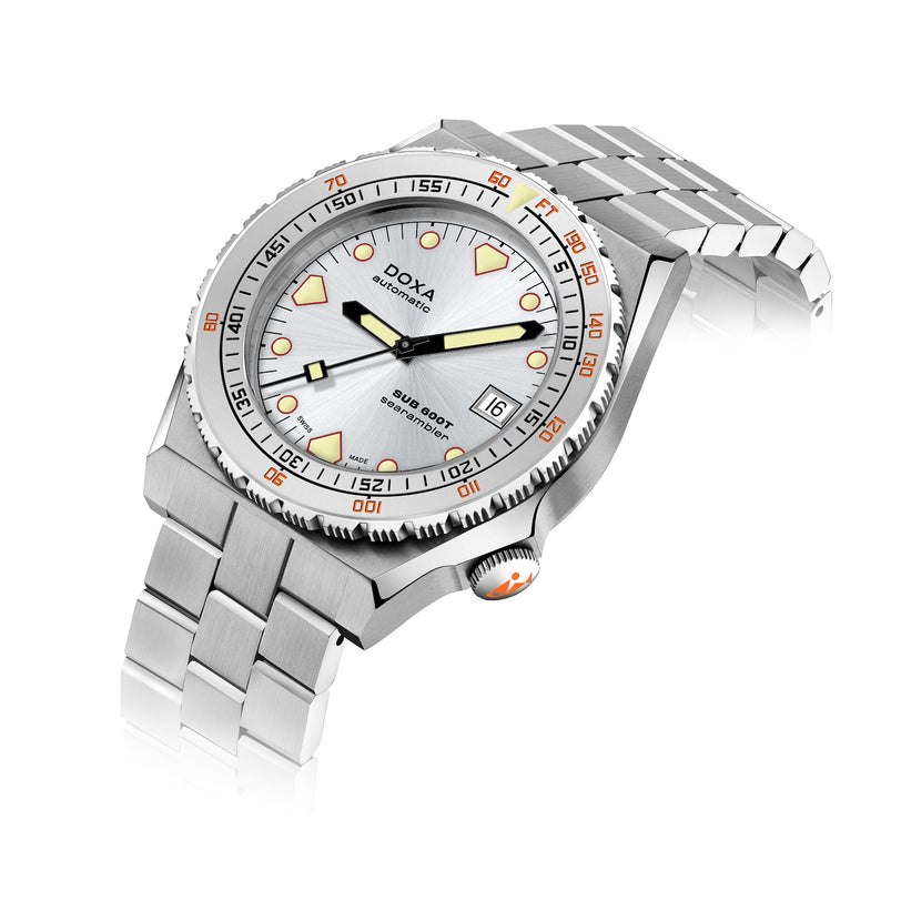 A stainless steel DOXA Sub 600T Searambler dive watch with a silver dial, date display at 3 o’clock, and orange accents on the markers, bezel, and crown, displayed against a white background.